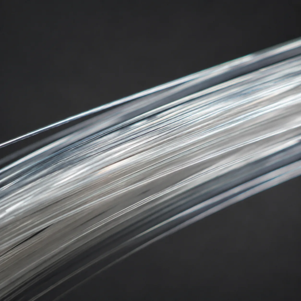 Macro photograph of smooth parallel polyester filaments.